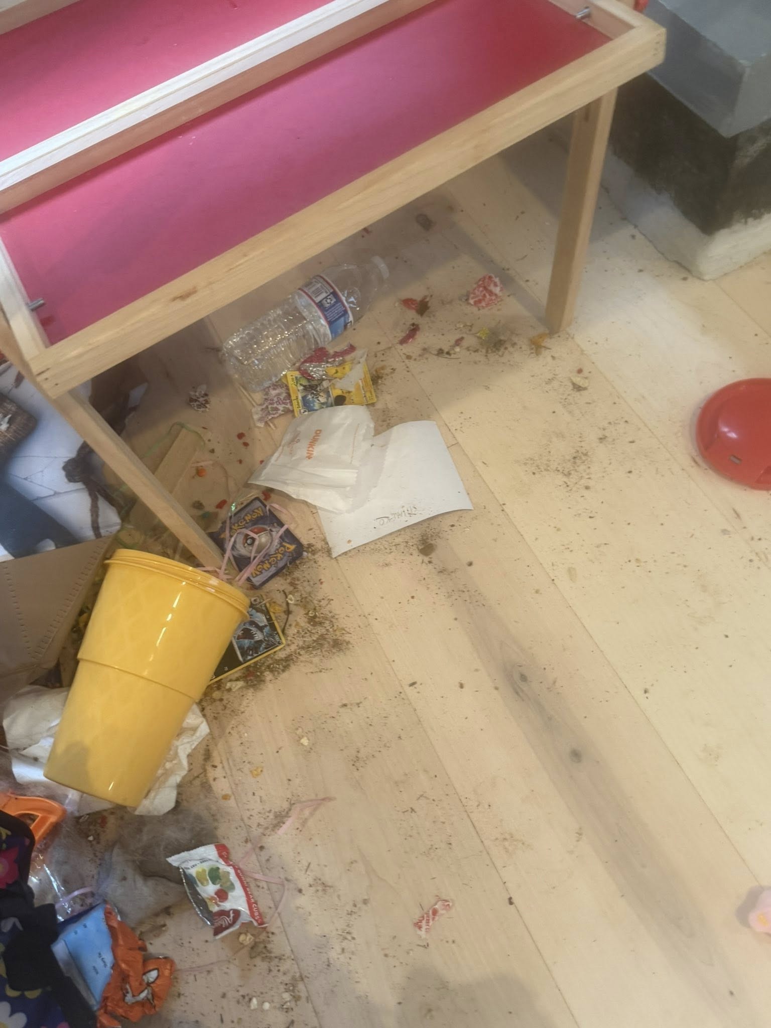 Cluttered playroom before cleaning